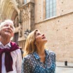 Senior Couple Of Tourists Visiting The Old Town In Barcelona