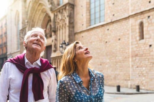 Senior Couple Of Tourists Visiting The Old Town In Barcelona