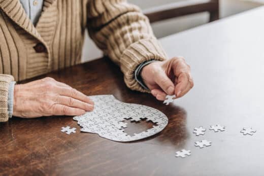 Cropped View Of Senior Man Playing With Puzzles