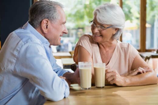 Happy Senior Couple Interacting While Having Coffee