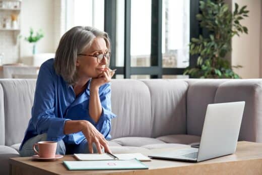 Senior Mature Older Woman Watching Business Training, Online Webinar On Laptop Computer Remote Working Or Social Distance Learning From Home. 60s Businesswoman Video Conference Calling In Virtual Chat