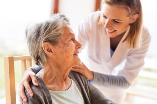 Health Visitor And A Senior Woman During Home Visit.