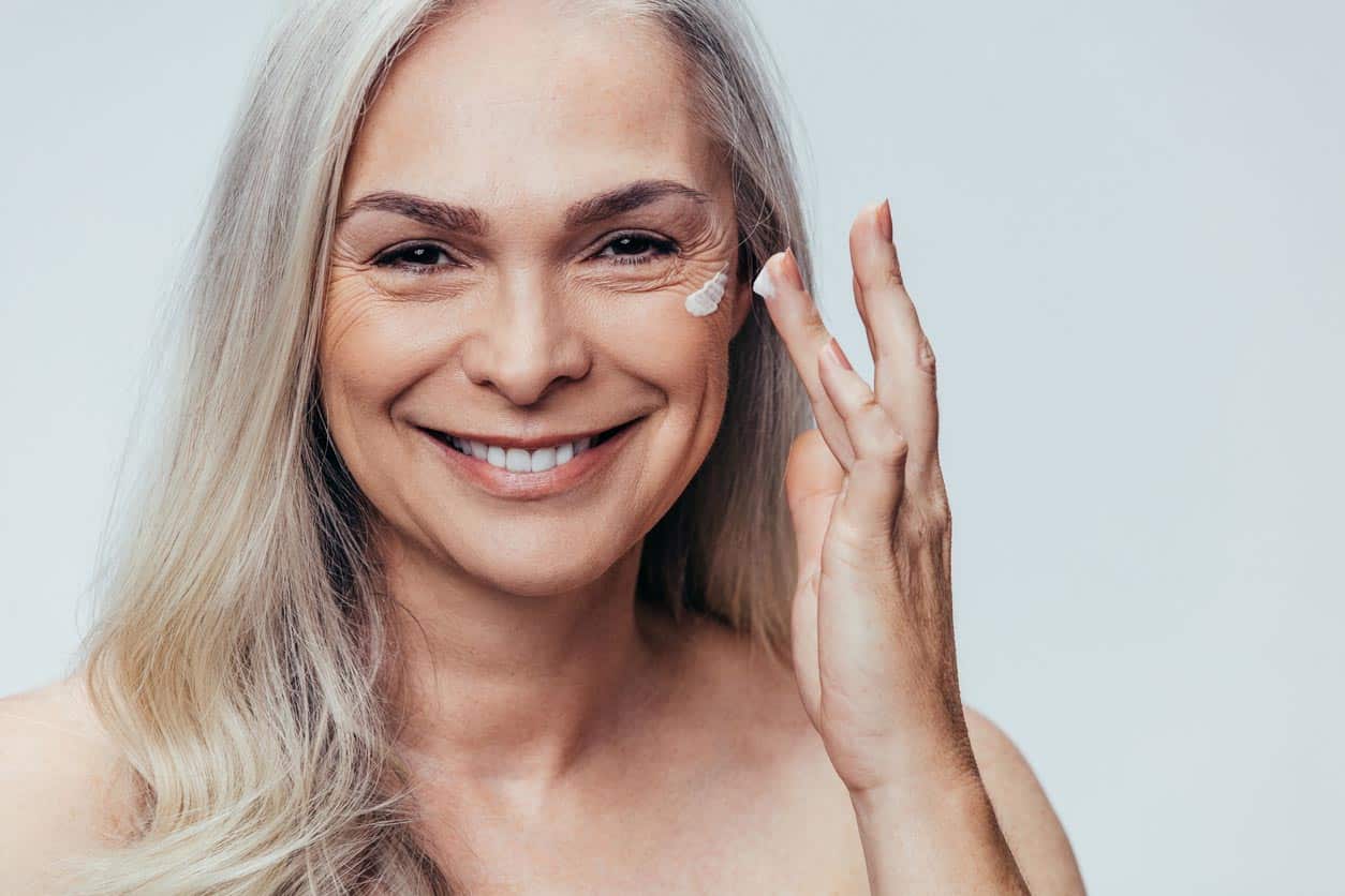 Senior Woman Applying Anti Aging Cream