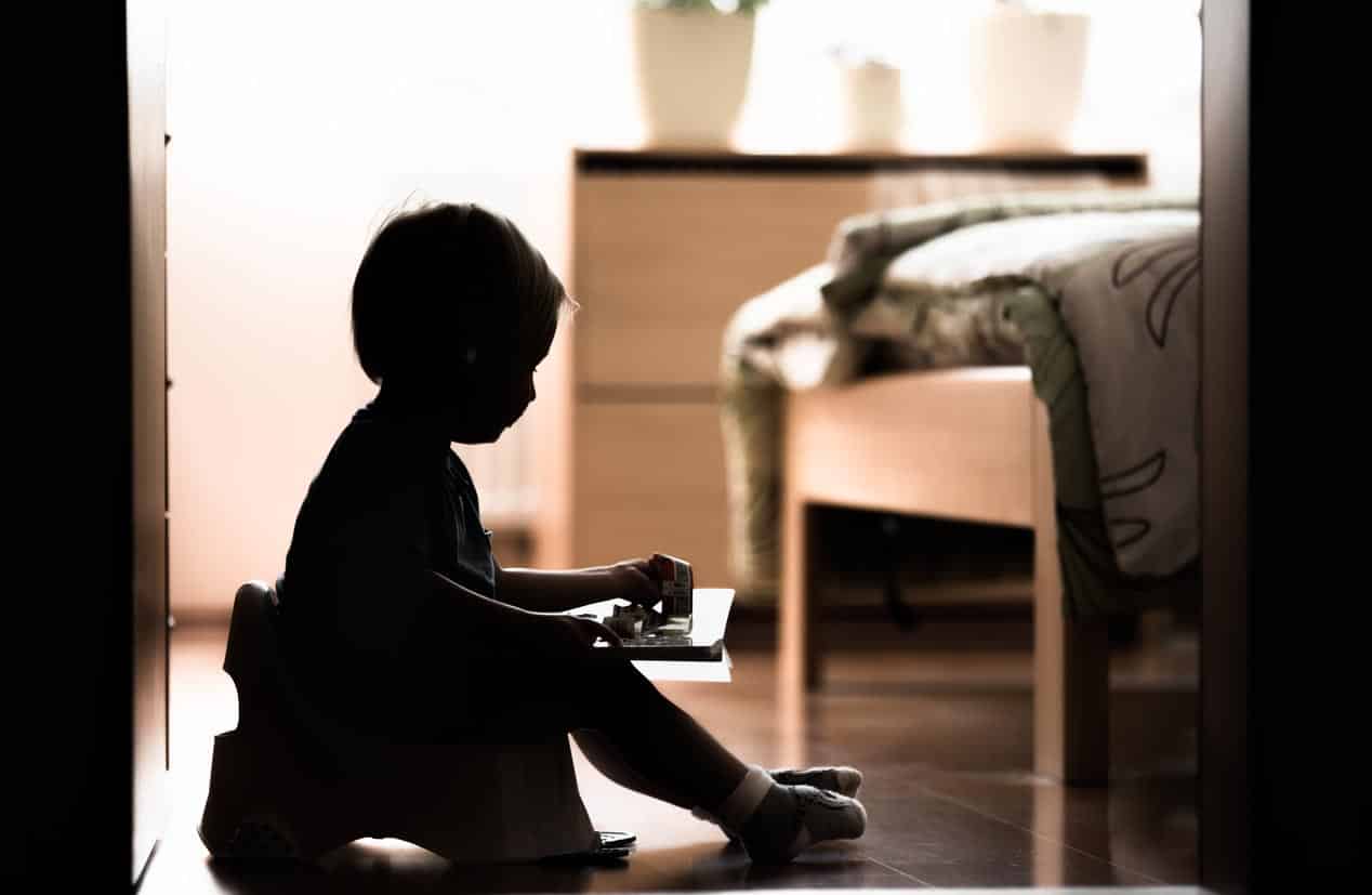 Cute Little Boy Sitting On A Potty.