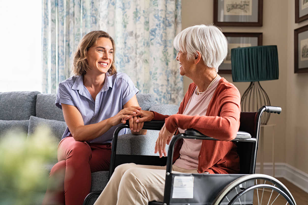 Happy Adult Woman Visiting Her Elderly Mother At Home